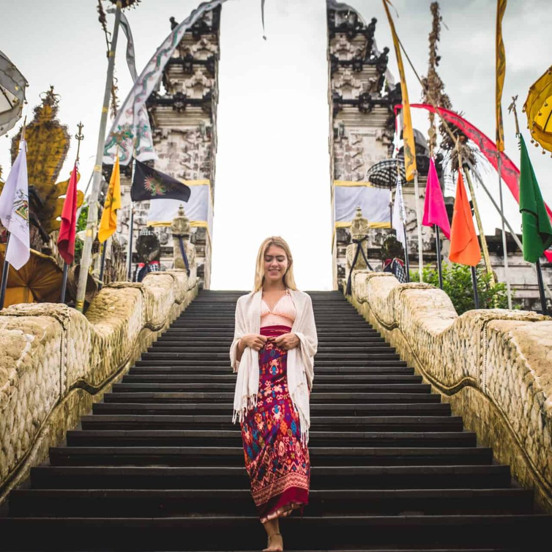 A woman at ancient gates in Pura Lempuyang ,Bali, Indonesia - Travel blogger exploring Bali landmarks